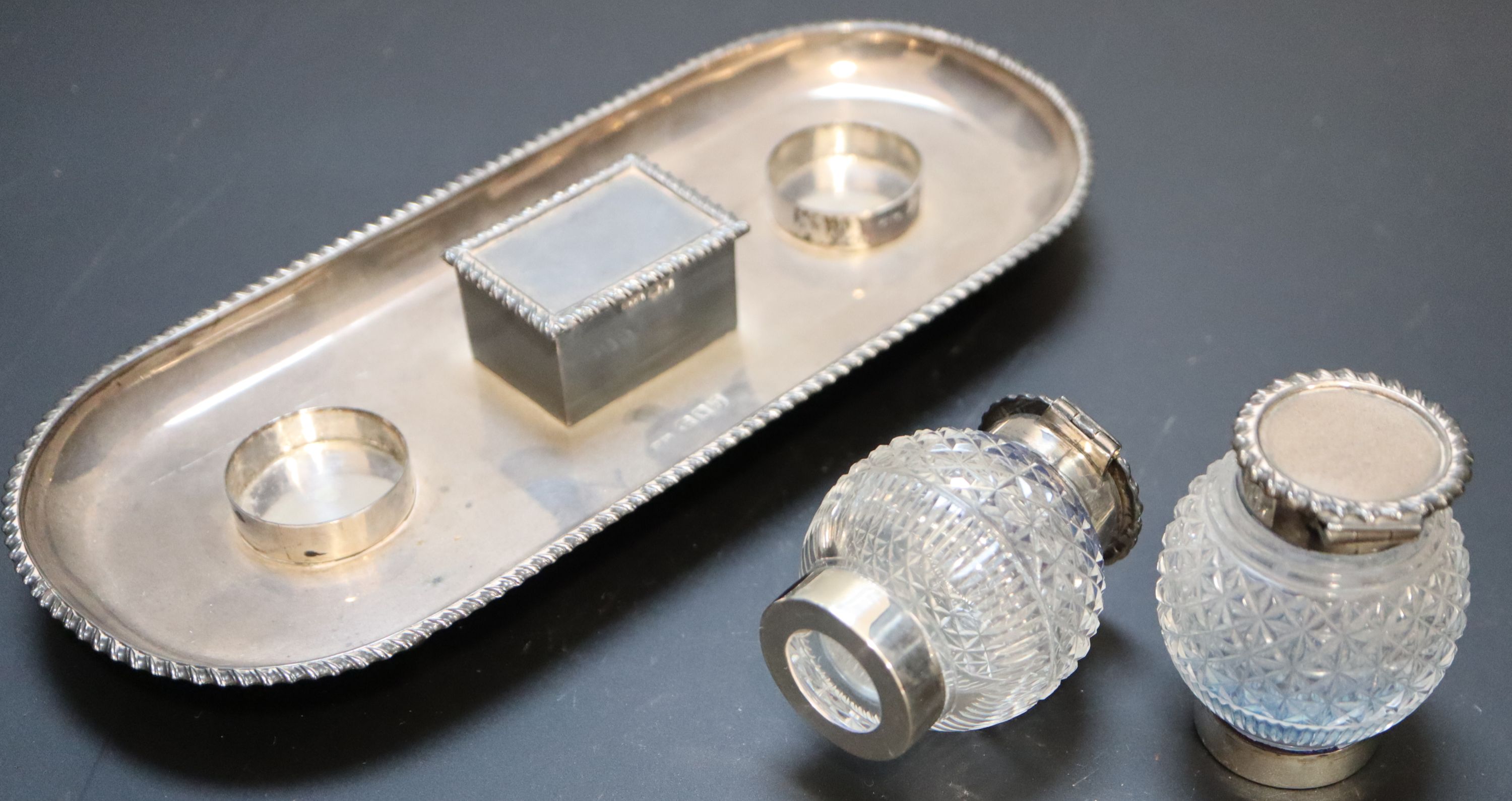 A late Victorian silver ovoid inkstand with two cut glass wells and central lidded compartment,
